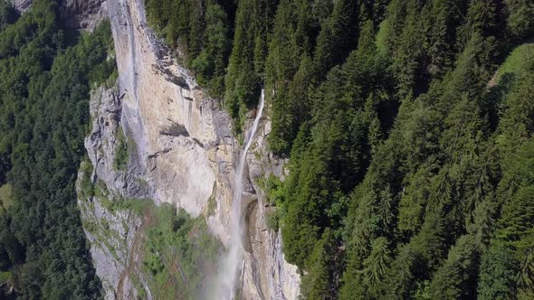 Aerial travel drone view of the Lauterbrunnen Valley and Staubbach Falls, Switzerland. alt