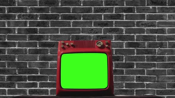 Retro TV Set with Green Screen Against Brick Wall.