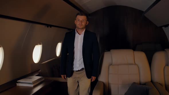 Businessman Confidently and Epicly Walking Inside Private Jet alt