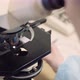 Scientist Examining Bacteria Under Microscope at Laboratory - VideoHive Item for Sale