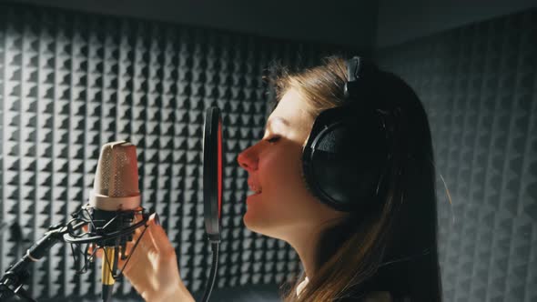Profile of Beautiful Girl Singing in Sound Studio alt