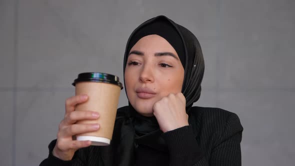 Thoughtful Concerned Business Muslim Woman in Hijab Thinking Solving Problem and Drinking Coffee
