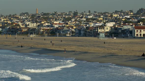 Volleyball courts stand empty on the beach in Hermosa Beach California. alt