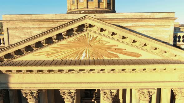 ancient building with huge columns and golden roof elements alt