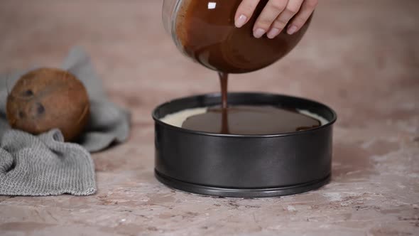 Pastry Chef Pours Liquid Chocolate On The Top Of The Cake To Decorate It.	