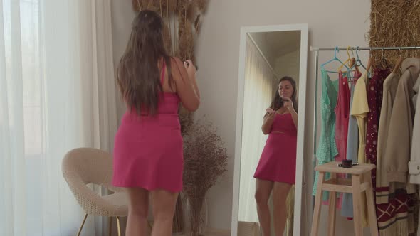 Plump Woman Singing Dancing in Front of Mirror Indoors Putting Makeup alt