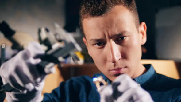 Gemstone in a Ring Is Getting Measured By the Jeweler. Jeweler Makes a Piece of Jewelry alt