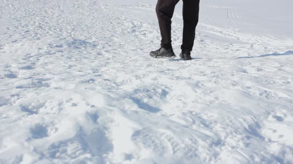 A Man Walks in the Snow in Winter