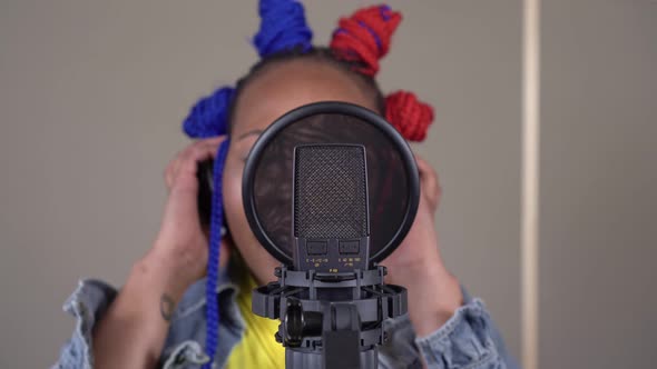 Recording Studio Microphone and Woman Singer Singing a Song alt