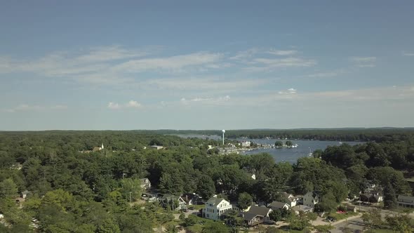 Rising aerial shot overlooking Pentwater lake in downtown Pentwater Michigan alt