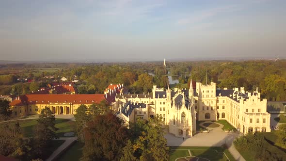 Aerial view of town Lednice and castle yard with green gardens in Moravia, Czech Republic. alt
