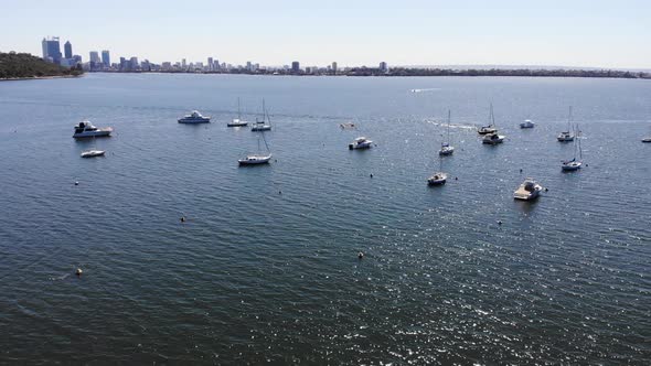 Aerial view of Boats by the City in Australia	 alt