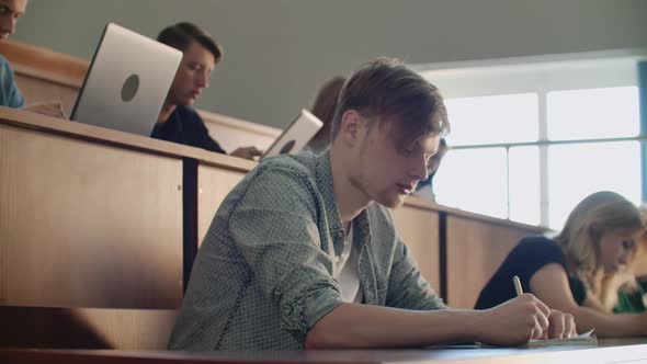 The College Current Audience in Which Students Listen to the Teacher and Write a Short Film Report alt