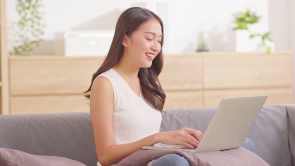 Asian young woman wear pink sweater online meeting Video conference call with business team or famil alt