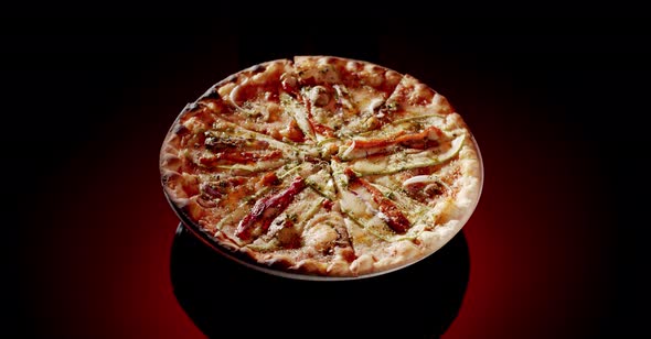 Delicious pizza spinning on plate alt