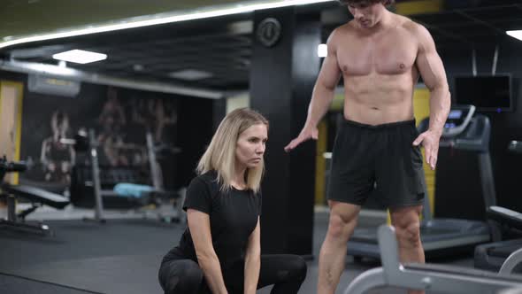 Woman Exercising with Trainer alt