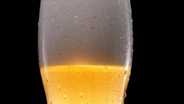 Cold Light Beer in a Glass with Water Drops