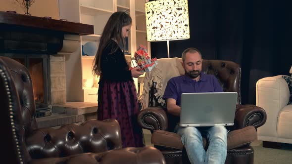 Busy Father Giving His Daughter Smartphone Instead of Playing Together