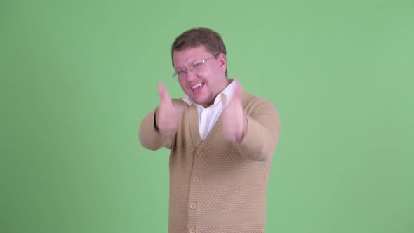 Happy Overweight Bearded Man Giving Thumbs Up and Looking Excited alt