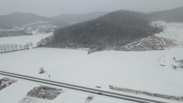 Drone view of valley in western Wisconsin during snowfall.