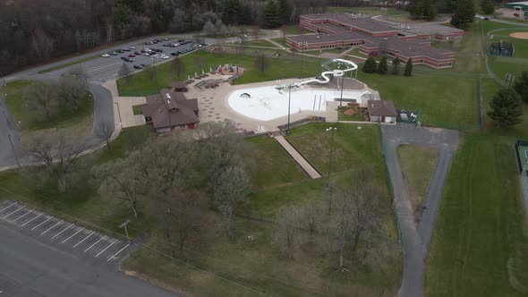 Aerial view of education center with sports and recreation facilities including swimming pool.