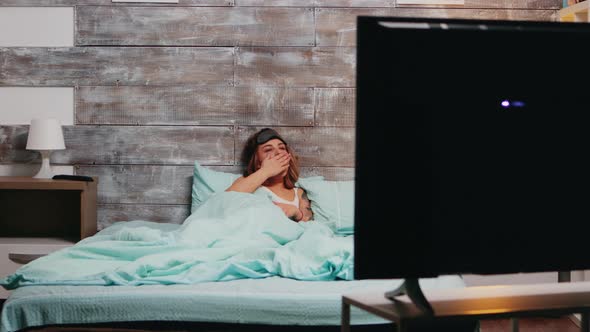 Sleepy Woman in Pajamas Clapping To Turn Off the Lights alt