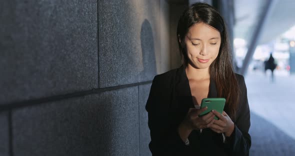 Business woman working on mobile phone alt