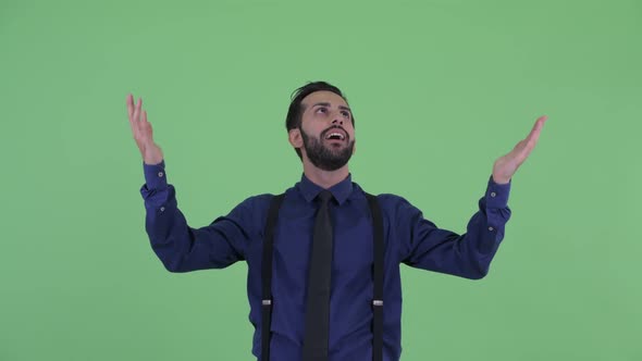Happy Young Bearded Persian Businessman Catching Something alt