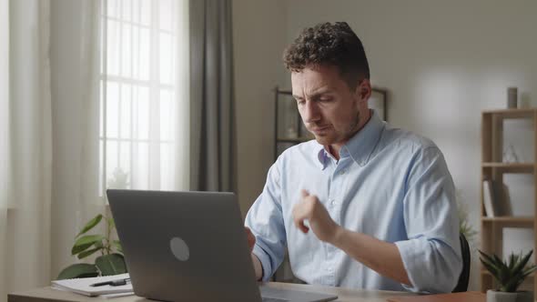 Young Male Employee Sit at Workplace Desk Working on Wireless Computer Makes Thinks Over Creative alt