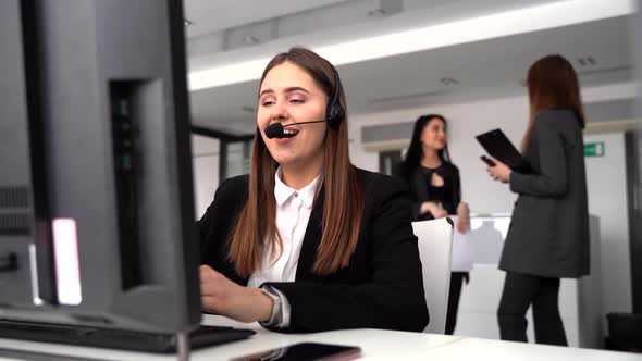 Business and Technology Concept-hotline Operator with Headphones in a Call Center