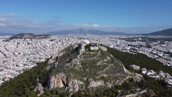 Drone View of Mount Lycabettus Surrounded By the Endless Quarters of Athens