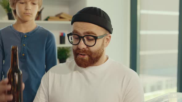 Close View of the Male Teacher Tells About the Difference Between Plastic and Glass and Why They alt