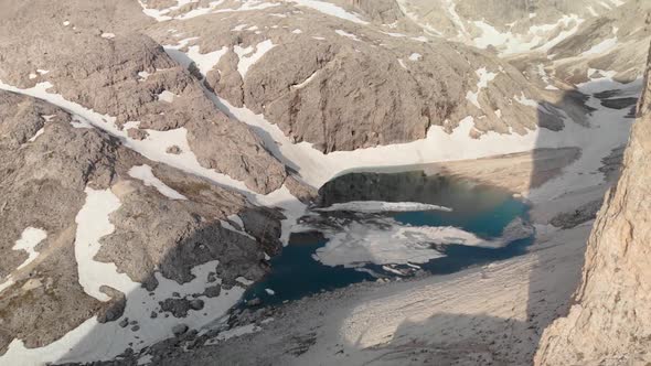 Aerial Crane Shot Unveiling Mountain and Alpine Lake Antermoia in Dolomites Italy