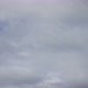Fast moving white fluffy clouds on a blue sky. Time-lapse of fast approaching cumulus clouds. - VideoHive Item for Sale