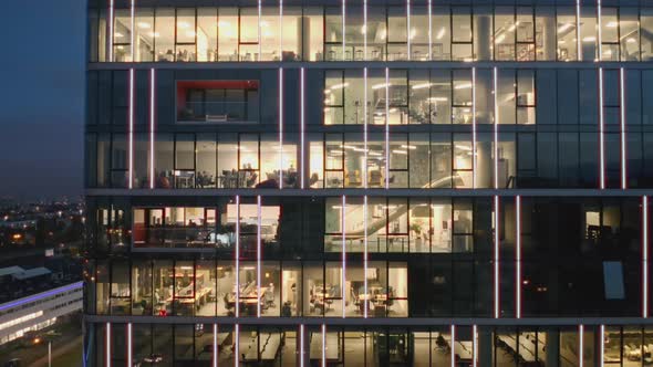 Aerial View of the Night Windows of Offices in a Modern Skyscrape alt