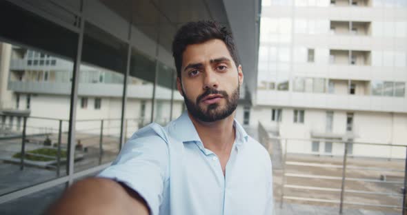 Pov Shot of Bearded Businessman Having Video Call Outside Business Center alt