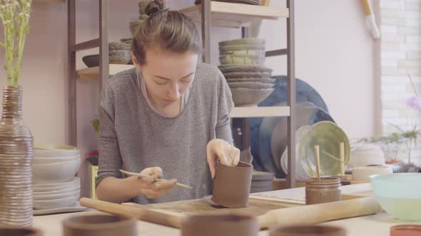 Young Woman Making Clay Mug alt