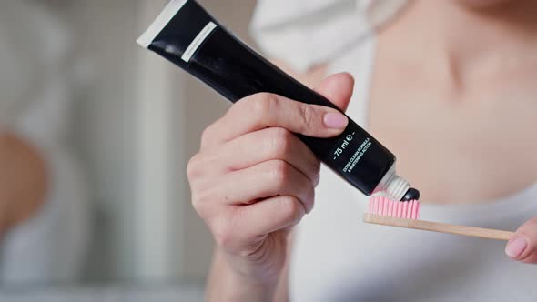 Detail of unrecognizable hand applying toothpaste on the toothbrush. Shot with RED helium camera in alt