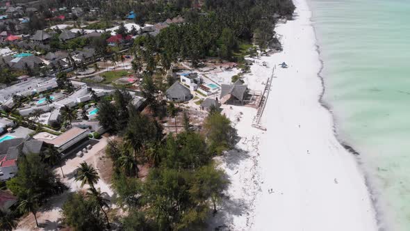Ocean Coastline with Paradise Beach Hotels and Palm Trees Zanzibar Aerial View alt
