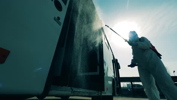 Bus Entrance Is Getting Chemical Treatment From a Disinfector alt