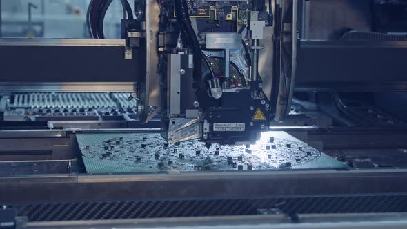 Surface Mount Technology SMT Machine places components on a circuit board alt