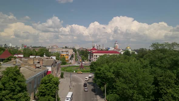 Aerial View of Roundabout Road with Circular Cars in Small European City at Sunny Day alt