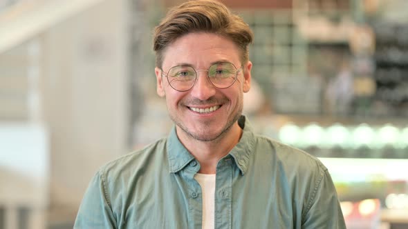 Portrait of Smiling Middle Aged Man Looking at Camera  alt