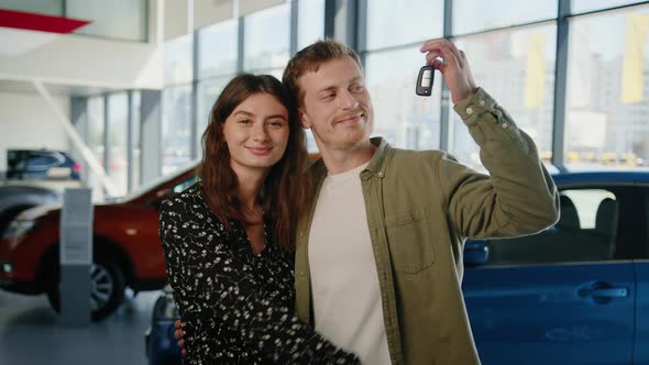 Happy Young Couple with Keys to a New Car alt
