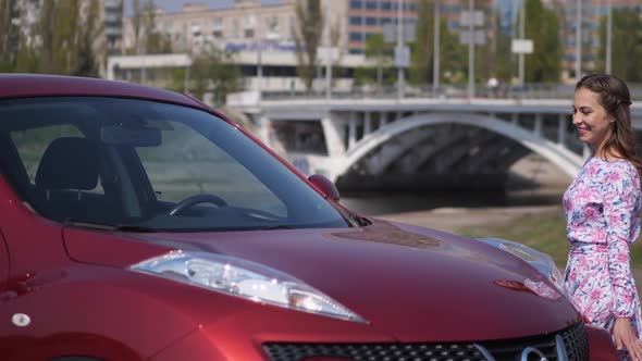 The Girl Saw a New Car Very Happy and Dancing Near Him alt
