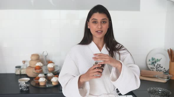Beautiful Smiling Girl Dressed in White Bathrobe Preparing Breakfast alt