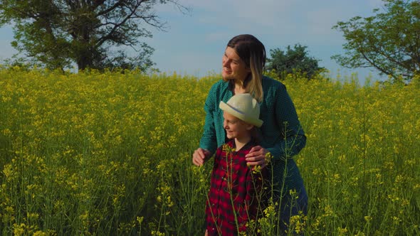 Mother and Daughter Farming Family in the Rapeseed Field alt
