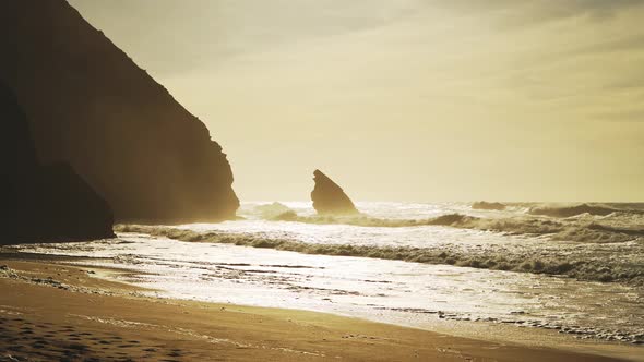 Praia Da Adraga Beach in Portugal, Lisbon (Lisboa) at Beautiful Orange Sunrise, With Waves Breaking alt