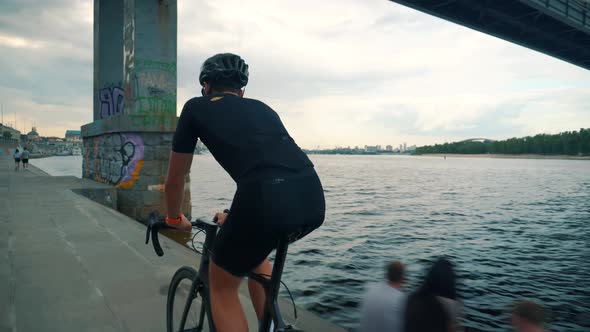 Triathlete Cyclist Training On Bicycle. Cyclist Fitness Riding On Road Bike. Fit Athlete Workout. alt