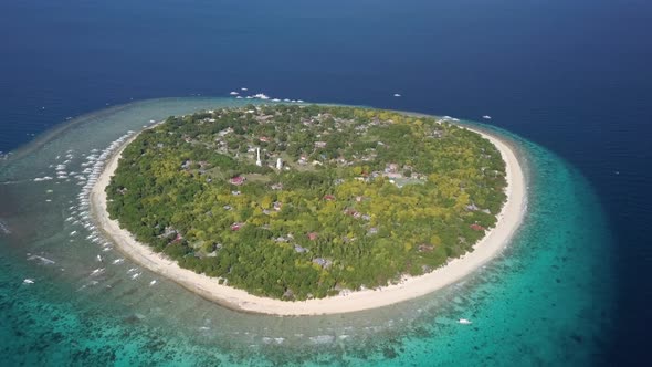 Aerial forward tracking shot panning down of Balicasag Island, Bohol, the Philippines alt